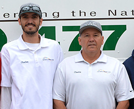 Charles Turner and his father standing together in front of the Natural Arbor Care truck.